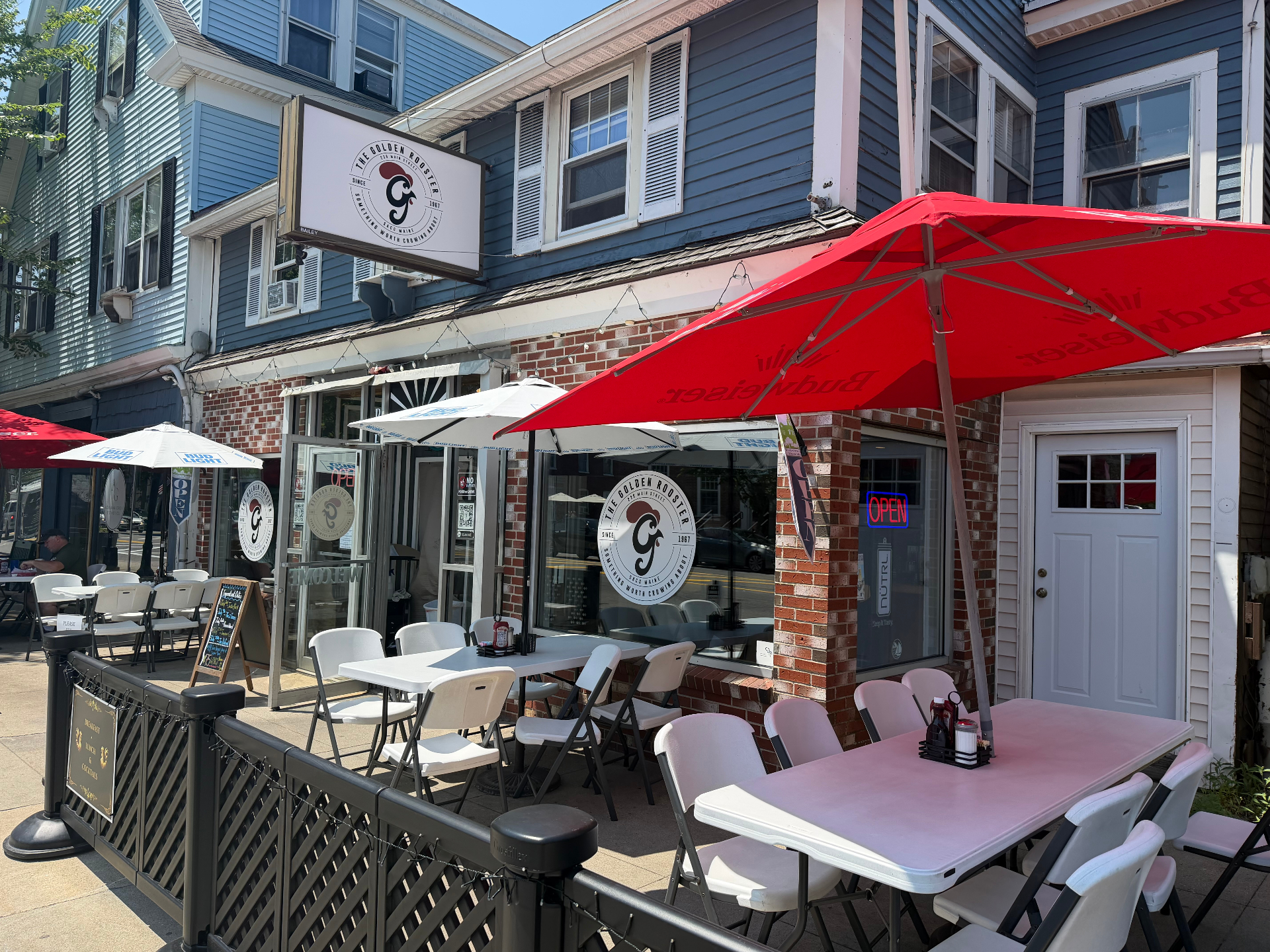Golden Rooster storefront and seasonal patio on Main Street in Saco, Maine
