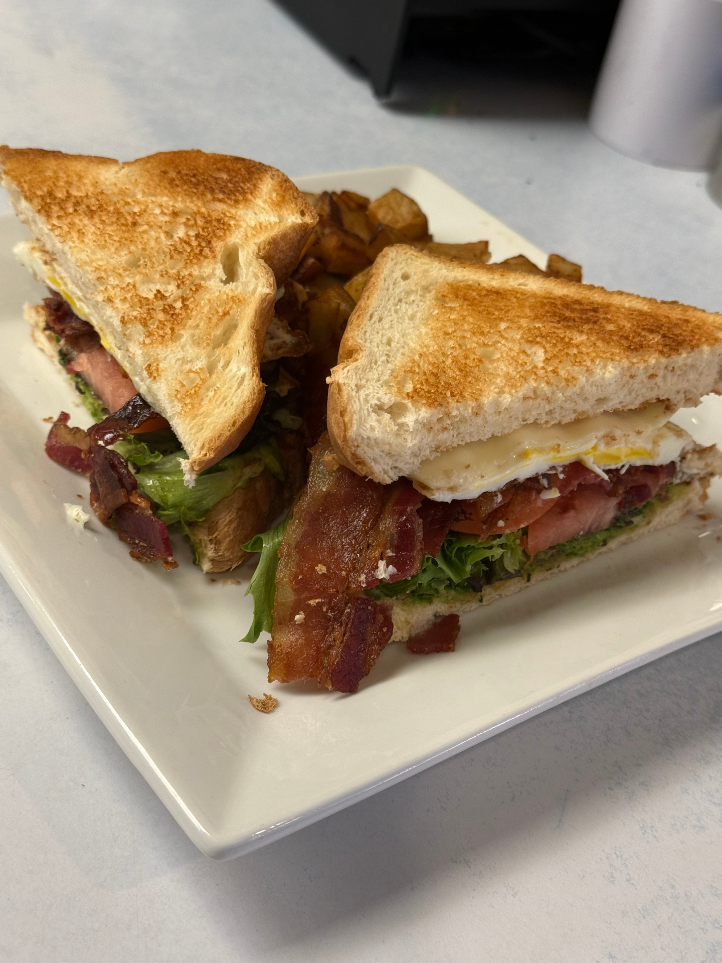 The Sunrise BLT with bacon, egg, lettuce and tomato on toast