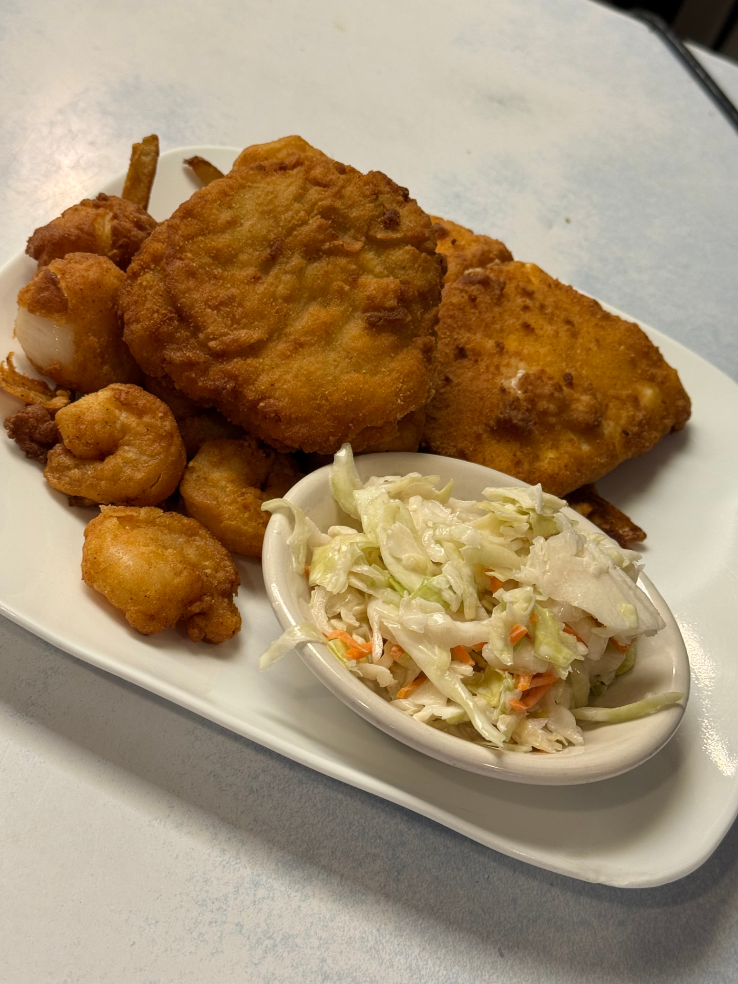 Fisherman's platter with fried haddock, scallops, shrimp, clams, fries and coleslaw