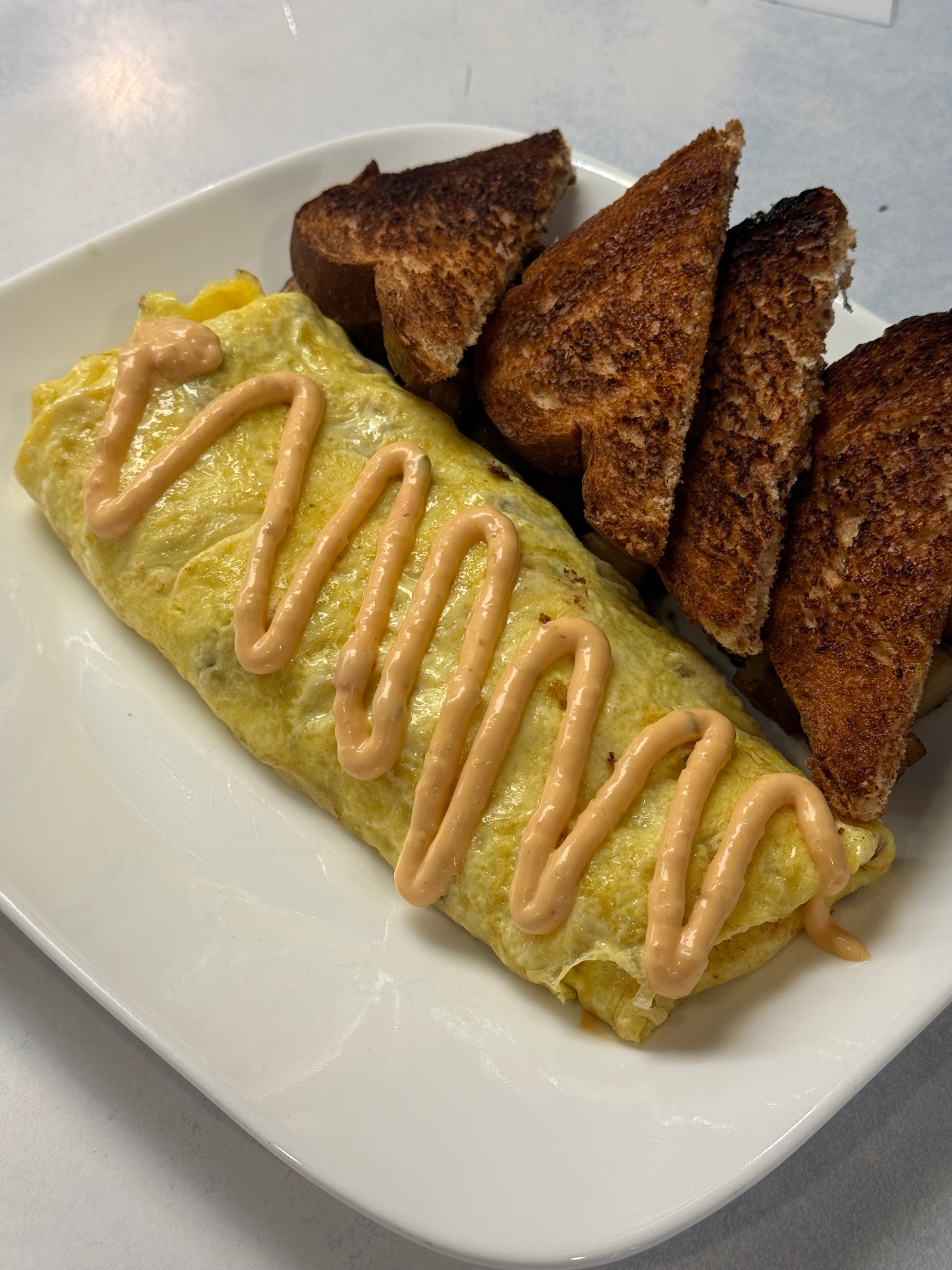 Reuben omelette drizzled with Russian dressing and rye toast